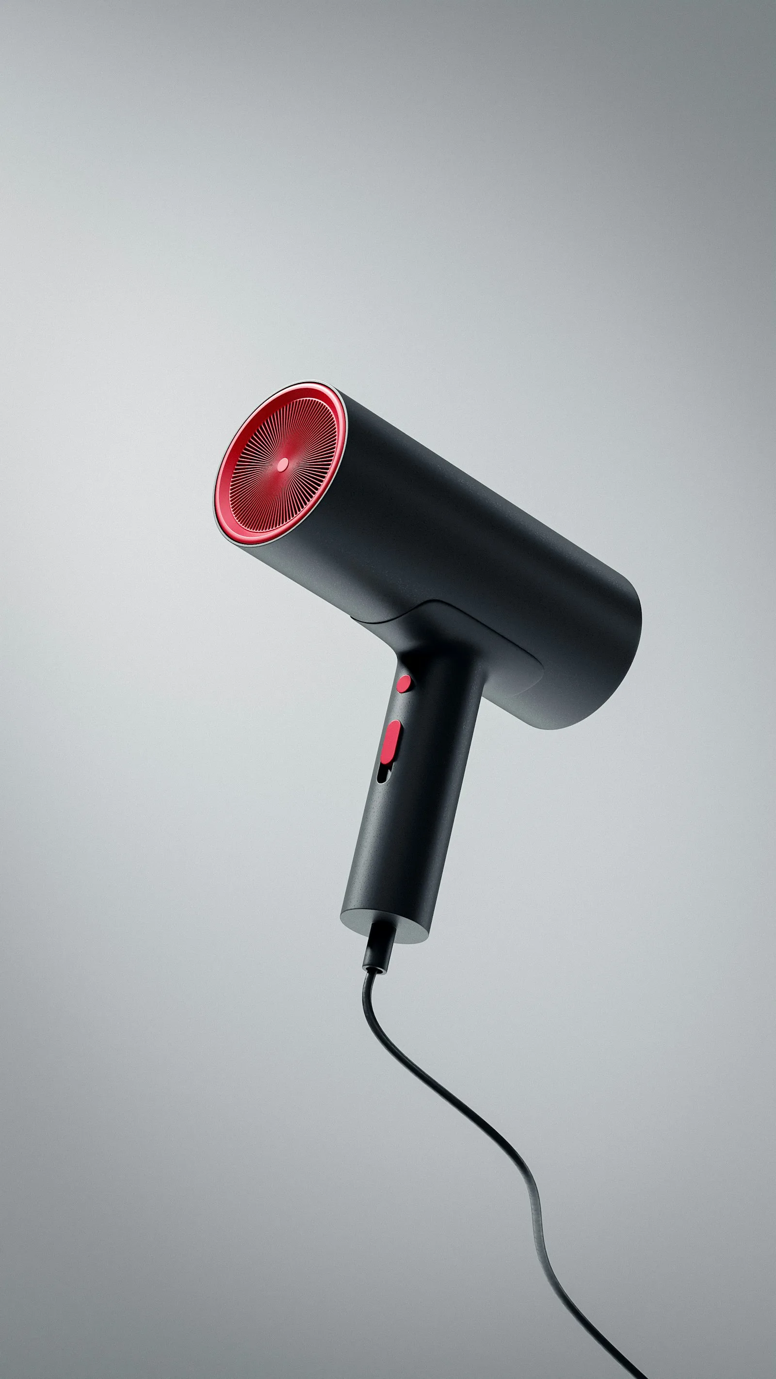 Sèche-cheveux noir à grille rouge posé debout sur fond gris uni